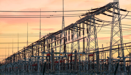Power transmission infrastructure silhouettes at sunset.