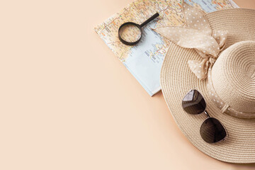 Straw hat, map, sunglasses and magnifying glass on pastel background. Summer holiday, vacation, travel concept. Flat lay, top view, copy space.