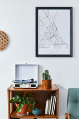Retro composition of living room interior with mock up poster map, wooden shelf, book,  armchair, plant, cacti, vinyl recorder and personal accessories in stylish home decor.