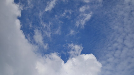 The sky is bright blue with white clouds that are very beautiful in the daytime