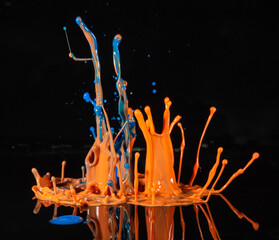 Abstract splash of color ink on black background