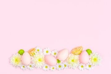 Creative layout composition of flowers and easter eggs on pastel background.
