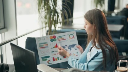 Charismatic beautiful girl gives a presentation on infographics