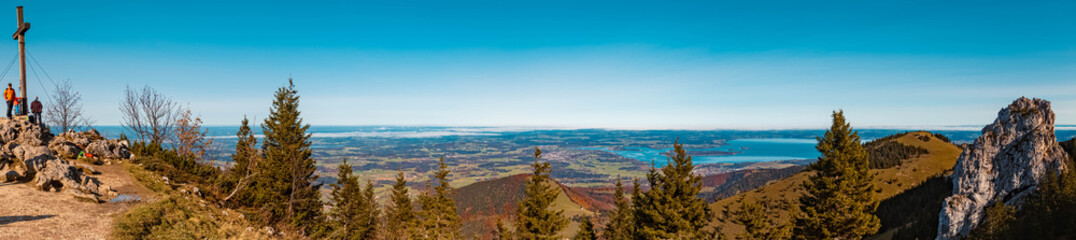 High resolution stitched panorama of a beautiful alpine autumn or indian summer view with the Chiemsee in the background at the famous Kampenwand summit, Aschau, Chiemgau, Bavaria, Germany