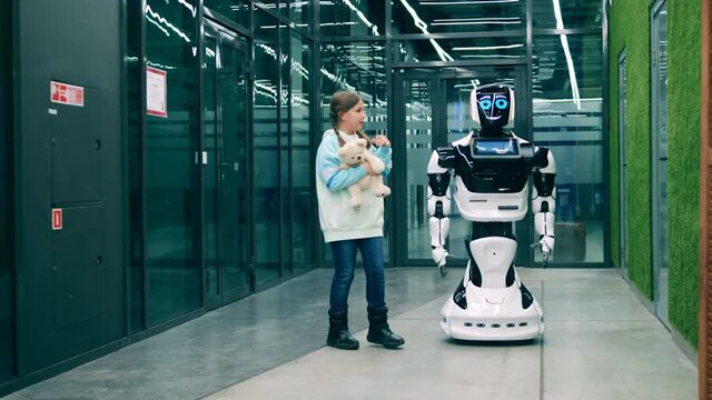 Little kid having a conversation with a futuristic robot