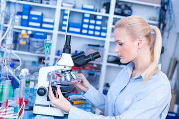 Laboratory assistant uses a polarizing microscope in a microbiological laboratory