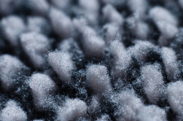 Warm warming fabric based on gray fleece material close-up, macro photography