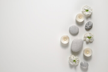 Composition with symbolic objects for spa salon. Stone therapy attributes for cosmetic procedures. Conceptual image, rocks and flowers representing balance. Close up, copy space, top view, background.