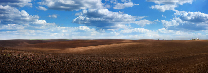 Panoramic view of hilly field. picturesque waves of a dirt field. hilly valley