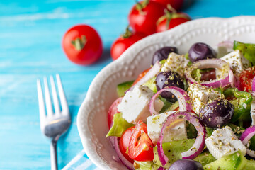 Greek salad with fresh vegetables, feta cheese and kalamata olives. Healthy food.