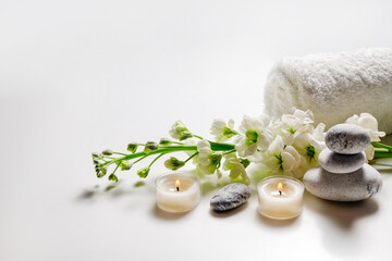 Composition with symbolic objects for spa salon. Stone therapy attributes for cosmetic procedures. Conceptual image, rocks and flowers representing balance. Close up, copy space, top view, background.
