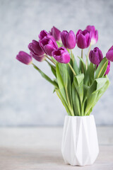 A bouquet of lilac tulips in a vase . A greeting card. Delicate flowers. Valentine's day. March 8. Mother's Day. Copy space