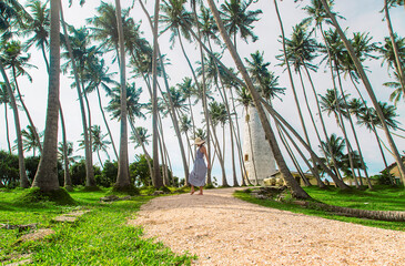 Girl in Sri Lanka on an island with a lighthouse. Selective focus.