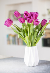 A bouquet of lilac tulips in a vase . A greeting card. Delicate flowers. Valentine's day. March 8. Mother's Day. Copy space