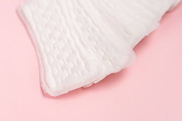 Women's hygiene daily pads on pink background