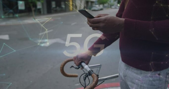 5g text and networking against mid section of man with bicycle using smartphone on the street