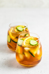 Summer drinks cucumber orange iced tea in glasses. Space for text.
