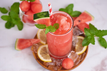 Fresh fruit smoothies, Homemade watermelon lemonade, portrait of summer fresh fruit drink. fruit flavored water mix with lemon, watermelon, mint leaves and ice. detox water cocktail, selective focus.