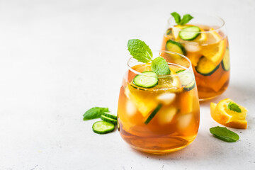 Cold brew cucumber orange iced tea in glasses. Space for text.