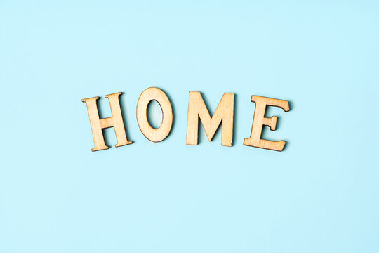 The inscription "home" in wooden letters on a blue background