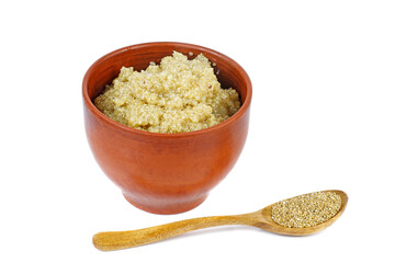Cooked white quinoa in clay bowl with wooden spoon isolated on a white background