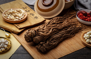 angelica，Ancient Chinese medicine books and herbs on the table.English translation：Emperor's Internal Classic