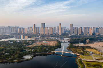 Obraz premium Aerial view of the modern city skyline with bridge and lake, and blue sky, in Xinglin Bay, Jimei District, Xiamen, China