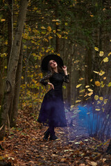 Fototapeta premium Fashion photo of woman with with creative make up in a forest. Fantasy