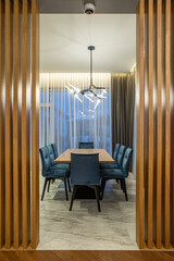 Huge wooden table and chairs. Interior of luxury kitchen in house.