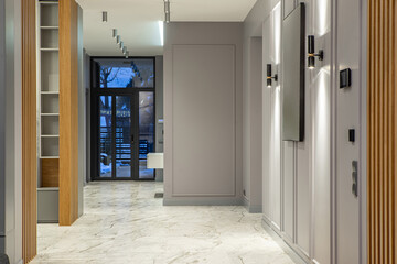 Grey and wooden interior of entrance hall in luxury house.