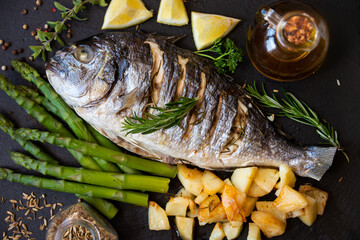 Roasted dorado fish with herbs and vegetables , healthy food