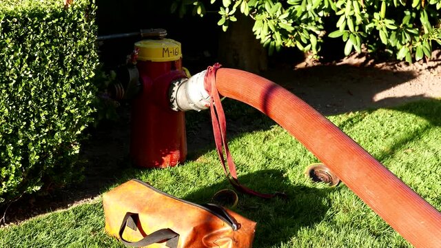 A hose connected to a fire hydrant on the fire scene