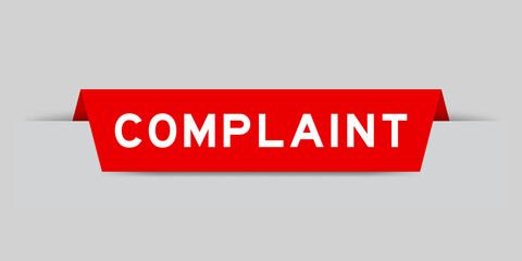 Red color inserted label with word complaint on gray background