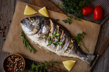Roasted dorado fish with herbs and vegetables , healthy food
