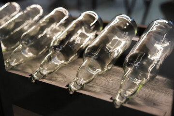 .Empty bottles on the shelf in the interior close-up