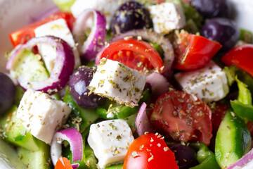 Greek salad with fresh vegetables, feta cheese and kalamata olives. Healthy food.