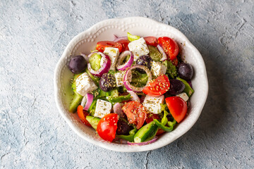 Greek salad with fresh vegetables, feta cheese and kalamata olives. Healthy food.