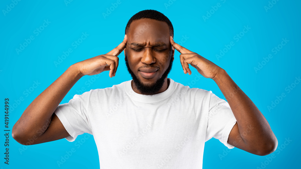 Wall mural Thoughtful African Guy Thinking With Eyes Closed Over Blue Background