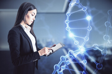 DNA programming and innovative technologies concept with businesswoman using digital tablet and digital DNA chromosome