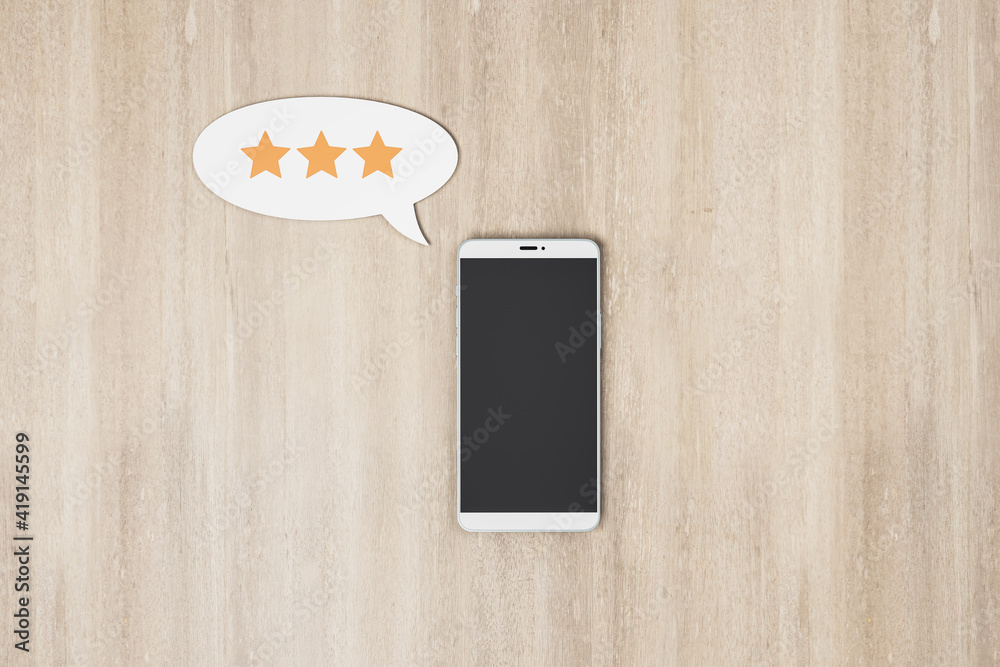 Poster rating feedback review concept with blank black smartphone screen and speech bubble with three stars