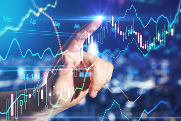 Forex trade market analysis concept with man finger pointing to financial diagram on digital board with stock market indicators