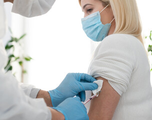Fototapeta premium hand of medical staff injecting coronavirus covid-19 vaccine in vaccine syringe to arm muscle of caucasian man for coronavirus covid-19 immunization, coronavirus covid-19 vaccination,