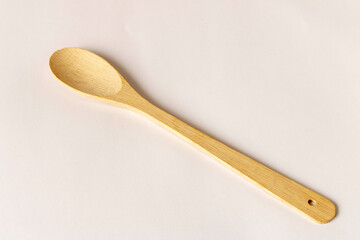 Wooden spoon on a light background. Close-up.