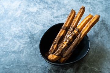 Churros Sticks with Chocolate Sauce . Fried Dough Pastry Traditional Spanish or Mexican Dessert.