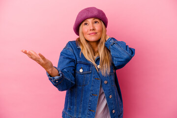 Young mixed race woman isolated on pink background screaming with rage.