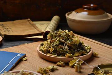 Ancient Chinese medicine books and herbs on the table.English translation：Emperor's Internal...