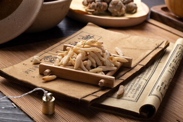 Ophiopogon japonicus，Ancient Chinese medicine books and herbs on the table
