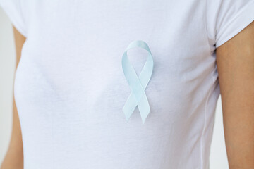 Woman with blue ribbon, prostate cancer awareness
