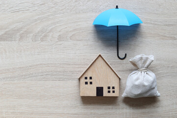 Protection, Model house and umbrella on white background, Finance insurance and Safe investment...