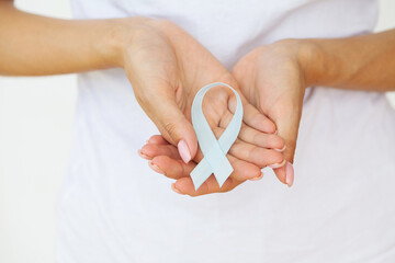Woman with blue ribbon, prostate cancer awareness